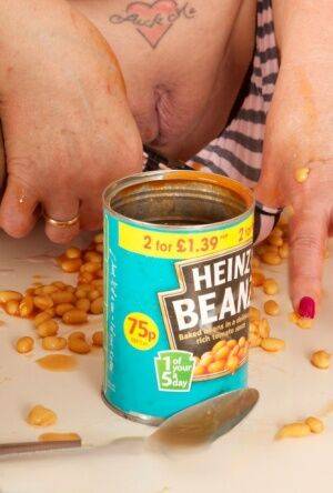 Mature amateur Dirty Doctor covers her naked body in a can of beans and sauce on nudesceleb.com