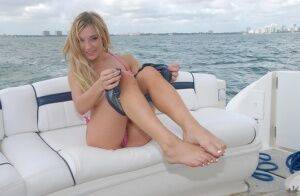 Lusty blonde Amy Brooke strips bikini and rubs pussy on the boat on nudesceleb.com