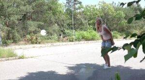 Blonde female Nikki Dream can't hold her pee any longer and squats on roadway on nudesceleb.com