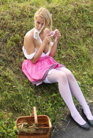 Cute blonde teen Nikki Dream hikes her skirt to masturbate in the countryside on nudesceleb.com