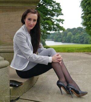 Clothed woman Sophia descends park steps in a long skirt and stiletto heels on nudesceleb.com