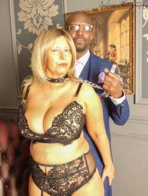 Overweight aged blonde Posh Sophia kneels afore her black owner while collared on nudesceleb.com