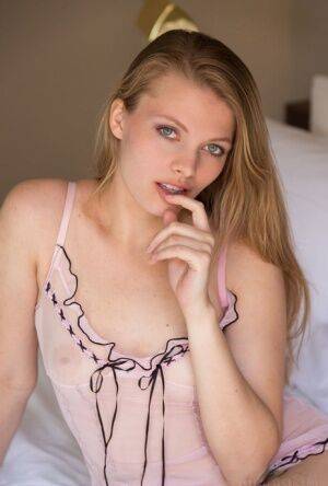 Nice teen Sophie Sparks sheds sheer lingerie to model naked on her bed on nudesceleb.com