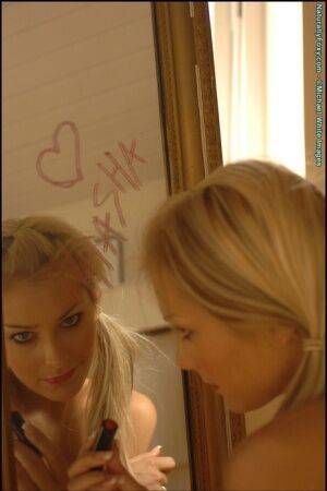 Gorgeous blonde Natasha Marley goes topless in front of a mirror on nudesceleb.com