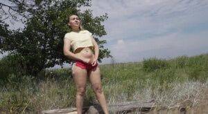 Gorgeous European sits on a log to piss outside on nudesceleb.com