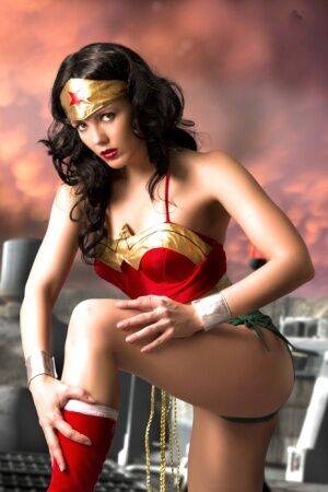 Beautiful brunette peels off her Wonder Woman outfit in a tempting manner on nudesceleb.com