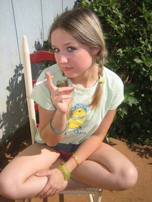 Cute teenage babe Shelby takes a smoke break and flashes us her perky tits on nudesceleb.com