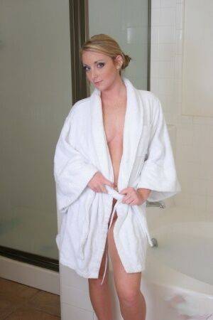 Blonde teen Abbie slips off a bathrobe for her first nudes in a bathtub on nudesceleb.com