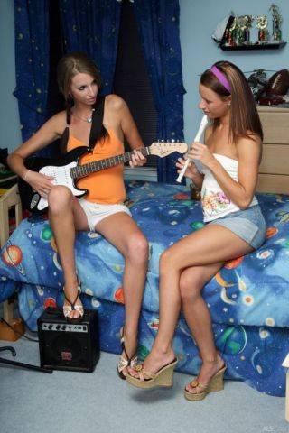 Sexy girls play some music and fuck with a huge strapon dildo on nudesceleb.com