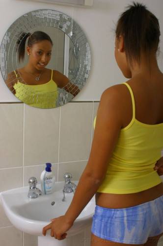 Ponytailed Ebony Teen Amy-Lou Displays Her Shapely Tits While Stripping In The Bathroom on nudesceleb.com