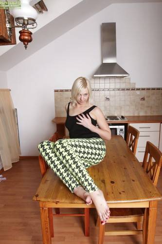 Superb blonde mature Emilia in foot fetish show in the kitchen on nudesceleb.com