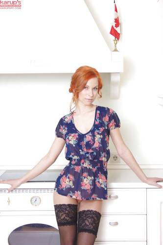 Hot czech redhead Daisy Lee in skirt baring her ass and bald pussy in the kitchen - Czech Republic on nudesceleb.com