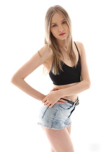 Slender blond teen Nimfa in sexy shorts shows tiny tits and spreads her legs on nudesceleb.com