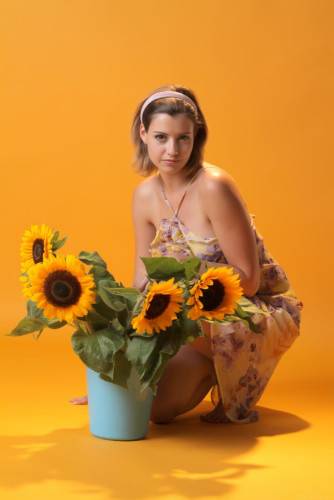 Wonderful Blonde Babe Vienna Is Getting Nude And Hotly Posing With Beautiful Sunflowers And Showing Her Boobs on nudesceleb.com