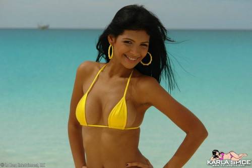 Round Titted Chica Karla Spice In Yellow Bikini Takes Sexy Poses On The Beach on nudesceleb.com