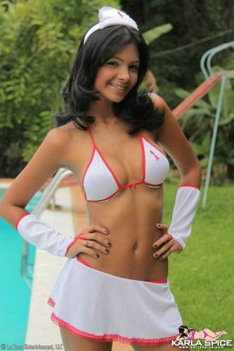 Swarthy Latina Karla Spice In White Uniform And Bikini Teasingly Poses By The Pool on nudesceleb.com