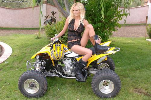 Lovely Blonde Hannah Hilton Dressed In Black Shows Her Assets On Quad Bike on nudesceleb.com