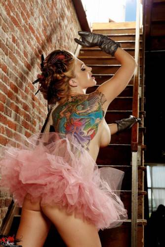 Tattooed Redhead With Big Boobs And Long Legs Jesse Capelli Poses On The Stairs on nudesceleb.com