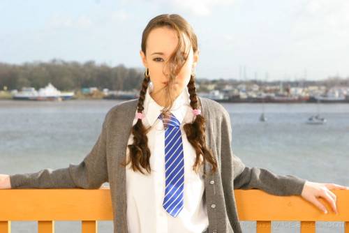 Flat Chested Schoolgirl Laura J In Pigtails Does Strip Tease On Balcony on nudesceleb.com