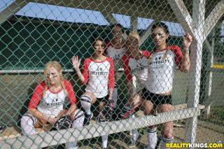 Several busty softball-playing hotties end up strap-on fucking each on nudesceleb.com