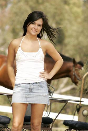 Sexy Brunette Doll Eden Petty In Jeans Skirt Makes A Strip Show By A Farm In The Country on nudesceleb.com
