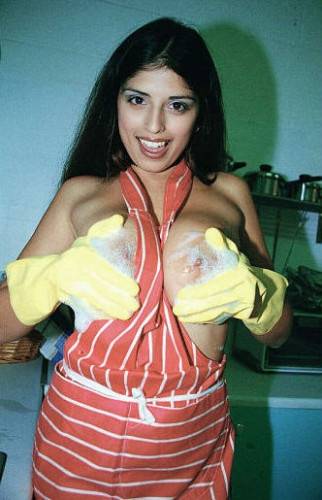 Naughty Housewife Kerry Marie In Yellow Gloves Demonstrates Her Huge Jugs And Twat on nudesceleb.com