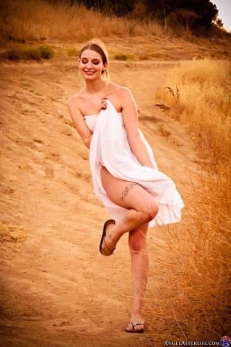 Naughty Blonde Ela Darling Plays And Poses Outdoors In The Middle Of Nowhere In A White Wrap on nudesceleb.com