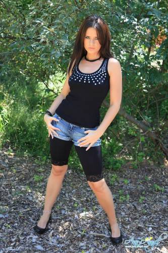 Alluring Brunette Ann Angel In Ultra Stylish Black Denim Shorts Poses In Nature on nudesceleb.com