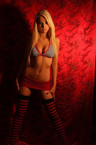 Glam Blonde XoXo Leah In Striped Stockings, Barely There Skirt And Tiny Bra Shows Her Tits And Slit on nudesceleb.com
