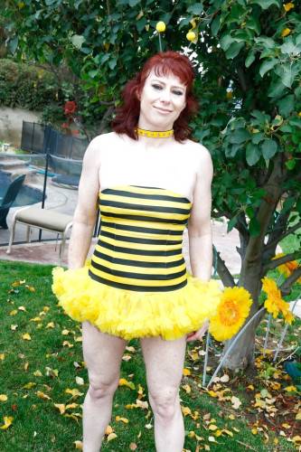 Hot red-haired mature Dirty Garden Girl in fancy skirt exhibiting her ass and jerking off outside on nudesceleb.com