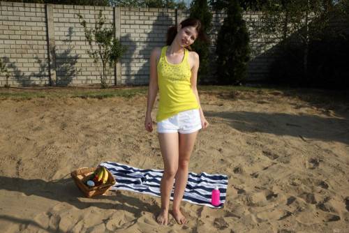 Licentious Brunette Judy Smile Is Stripping Nude On The Beach And Feeding Nub With Banana on nudesceleb.com
