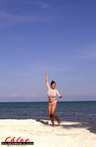 Seductive german dark-haired milf Chloe Vevrier in beautiful bikini shows big tits and spreads her legs on the beach - Germany on nudesceleb.com