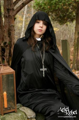 Naughty Teenage Nun Ariel Rebel Dressed In Black Flashes Her Bald Pussy Outdoors on nudesceleb.com